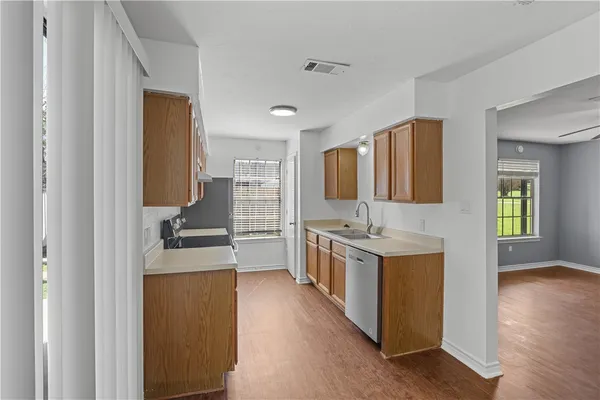 a kitchen with a stove top oven sink and cabinets