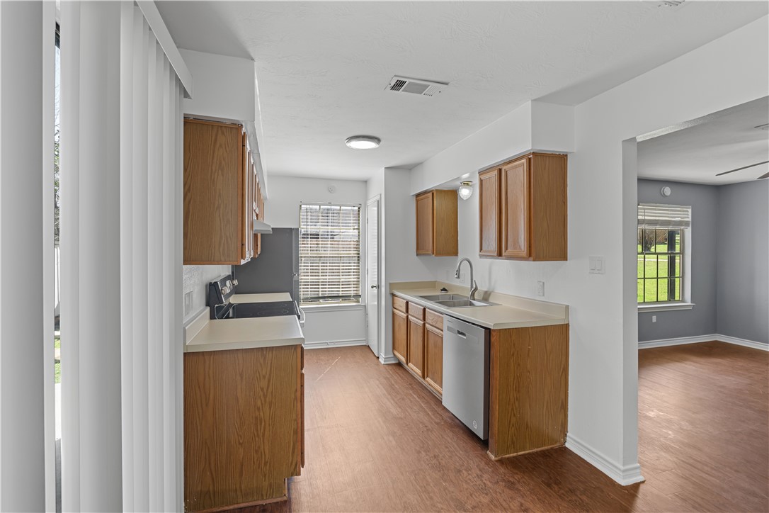 401 Park Road, Unit AB College Station, TX 77840 - Photo 8 of 22 a kitchen with a stove top oven sink and cabinets