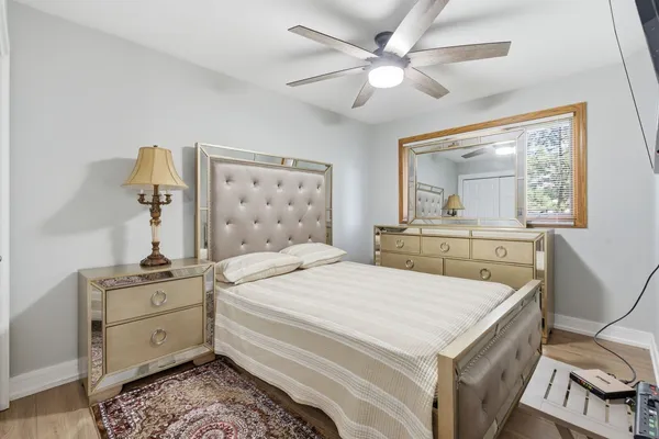 a bedroom with a bed and a chandelier
