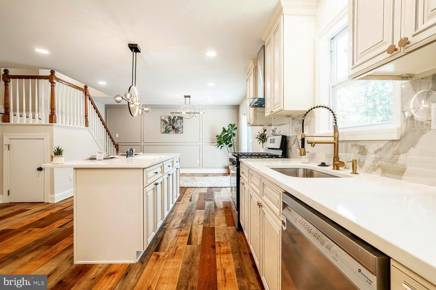 431 East Park Avenue Maple Shade, NJ 08052 - Photo 11 of 36 a kitchen with kitchen island a sink appliances cabinets and a large window