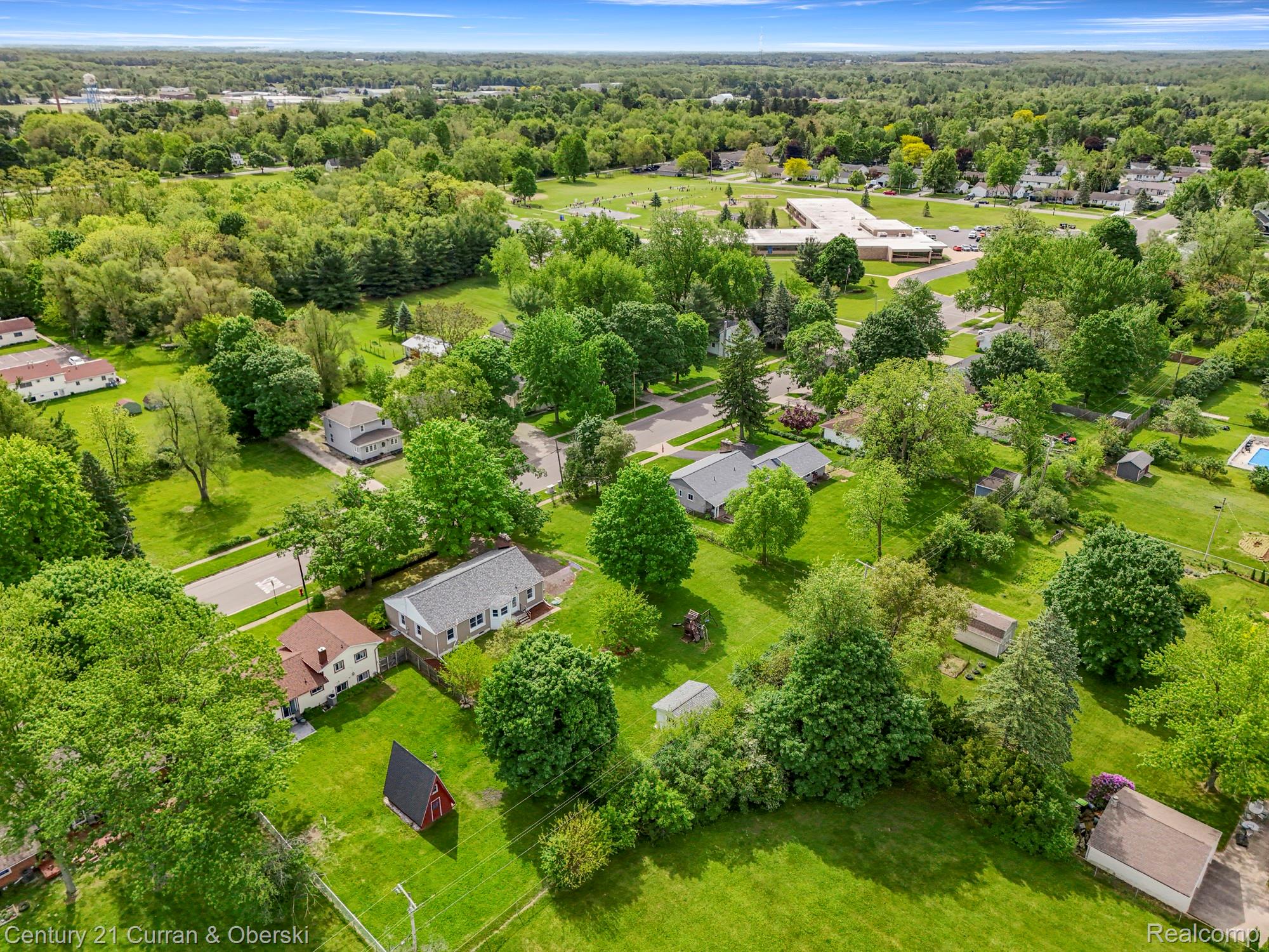 411 South Adrian Street Tecumseh, MI 49286 - Photo 50 of 61 Aerial view of residential area with a forest