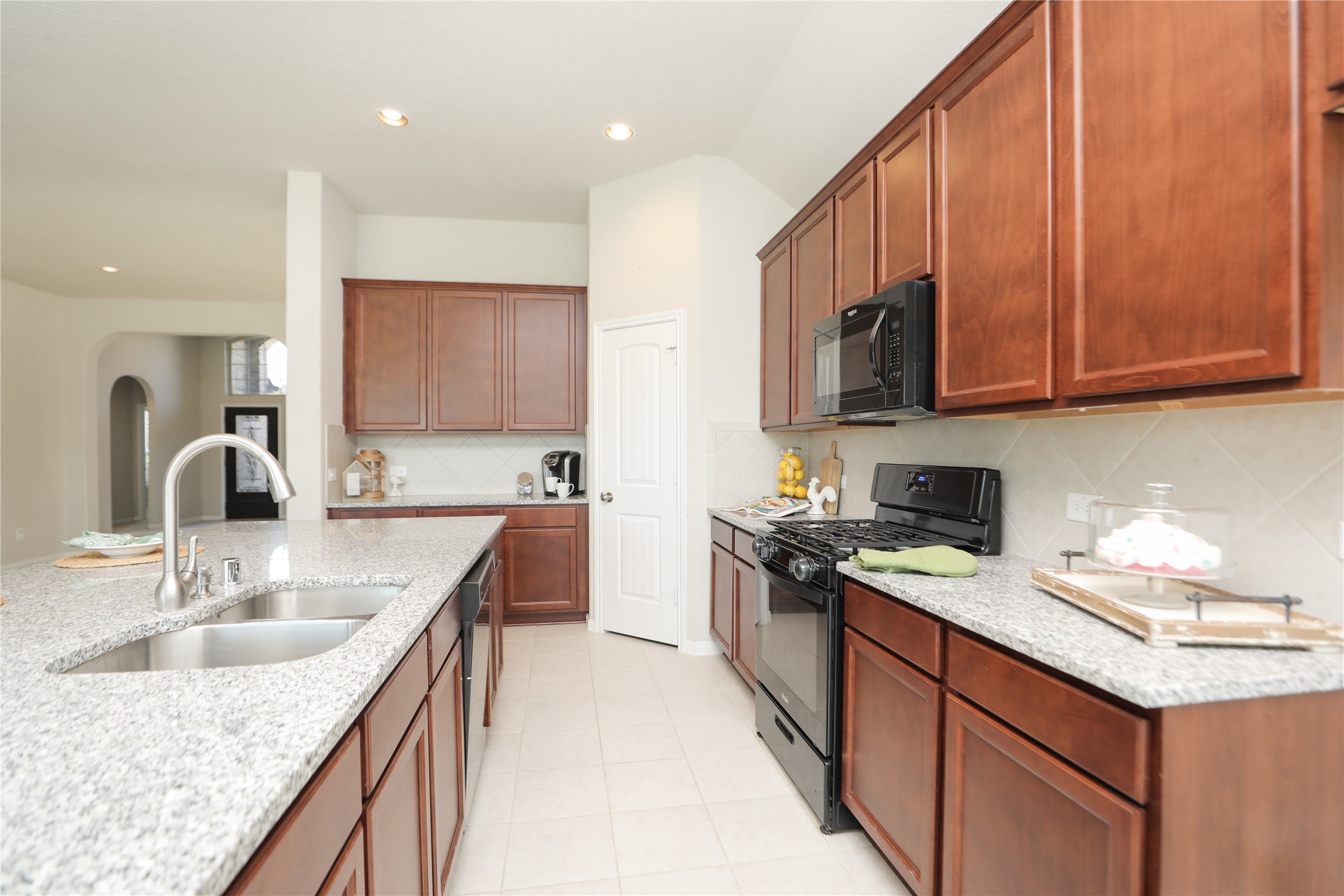 17506 Field Row Trail Hockley, TX 77447 - Photo 6 of 27 a kitchen with stainless steel appliances granite countertop a sink stove and refrigerator