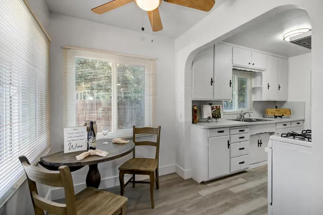 a kitchen with stainless steel appliances granite countertop a white cabinets and a stove