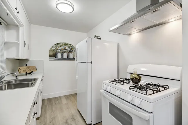 a kitchen with a stove and a refrigerator