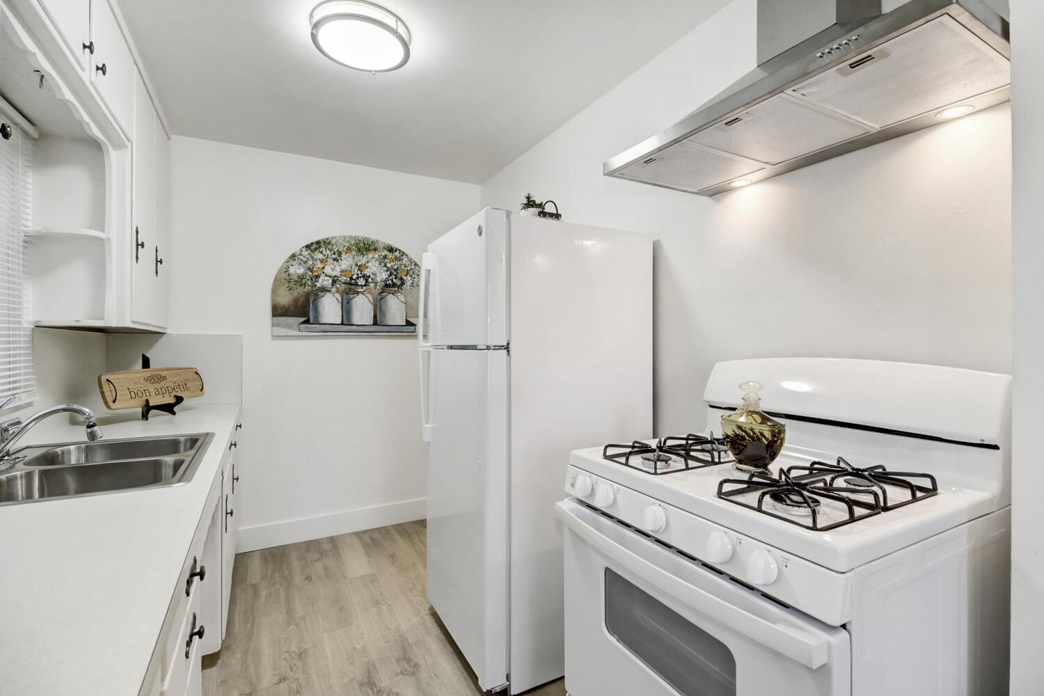 218 Folsom Road Roseville, CA 95678 - Photo 13 of 37 a kitchen with a stove and a refrigerator