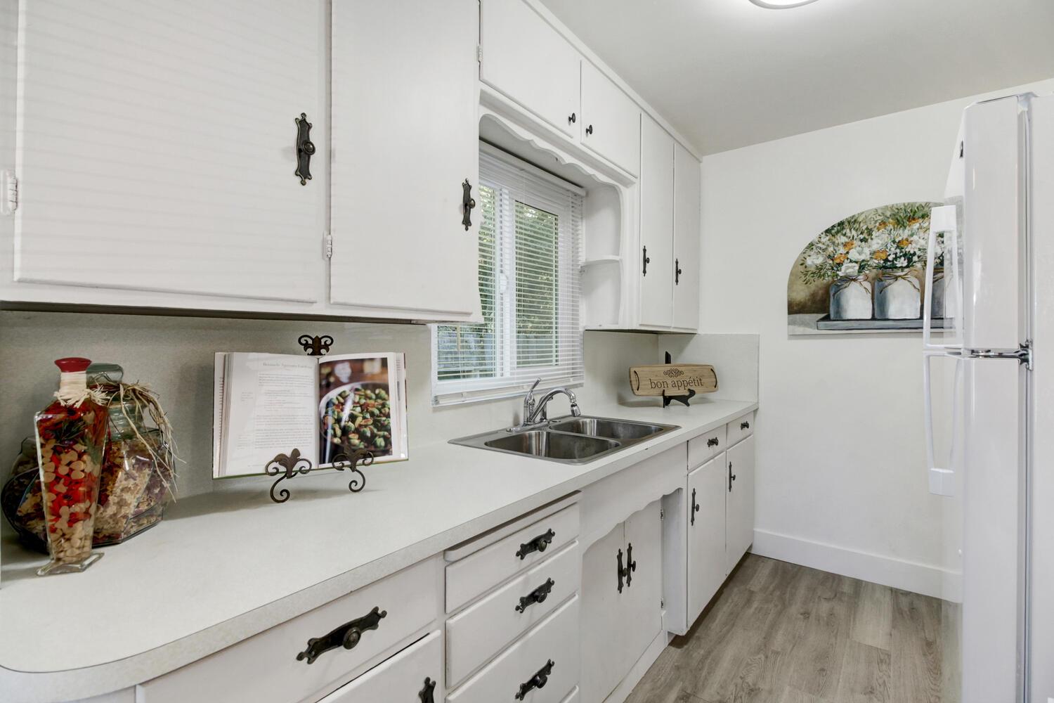 218 Folsom Road Roseville, CA 95678 - Photo 14 of 37 a kitchen with a sink and cabinets