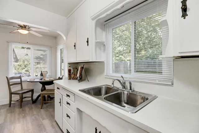 a kitchen with a sink cabinets and a large window