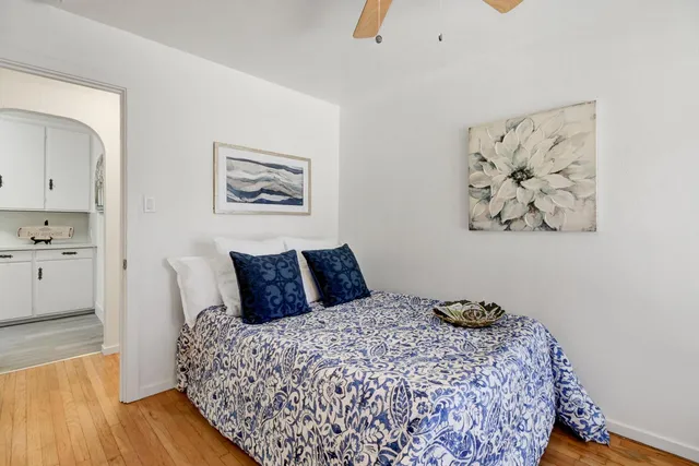 a bedroom with a bed and wooden floor