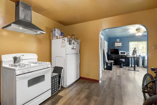 a kitchen with a stove and a refrigerator