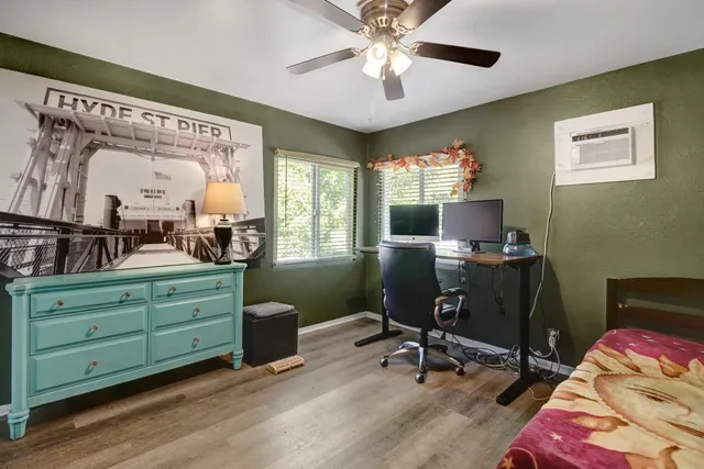 a view of a workspace with furniture and a window