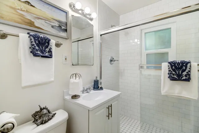 a bathroom with a sink mirror and vanity