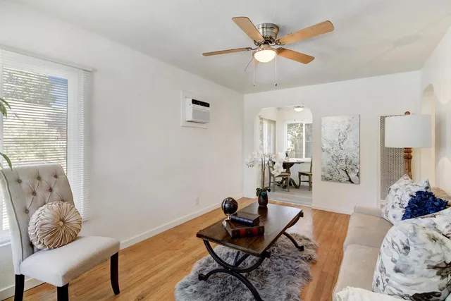 a living room with furniture and wooden floor