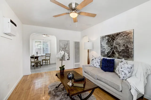 a living room with furniture and wooden floor