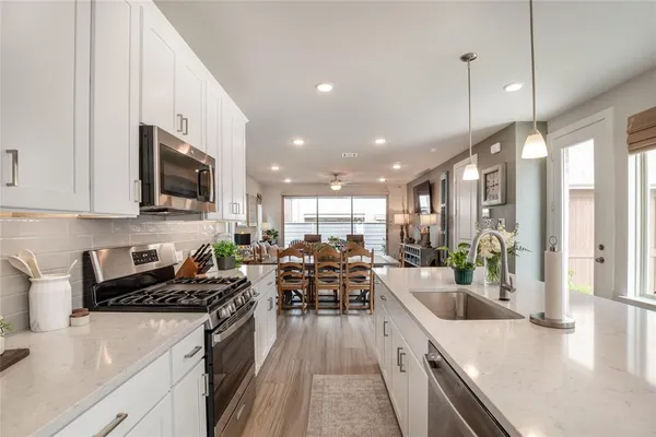 a kitchen with lots of counter top space a sink and appliances