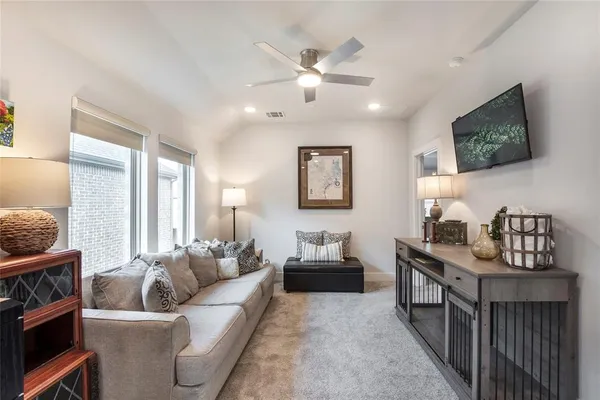 a hallway with a couch and chandelier