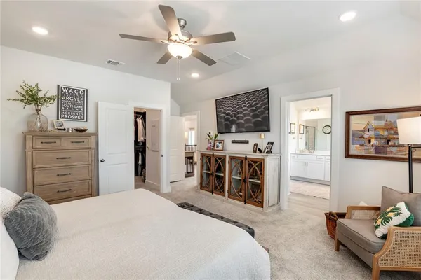 a bedroom with furniture and a large window