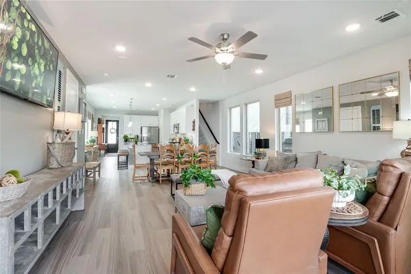a view of a dining room with furniture and a chandelier