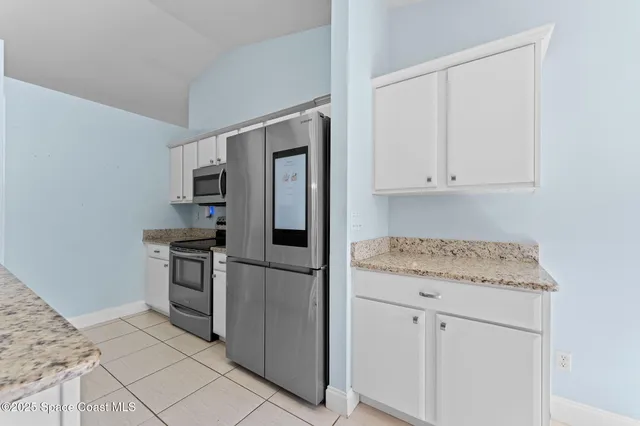 a kitchen with granite countertop cabinets and steel stainless steel appliances
