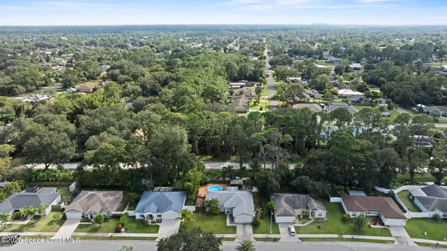 an aerial view of a houses with a yard