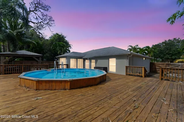 a view of a house with pool and sitting area