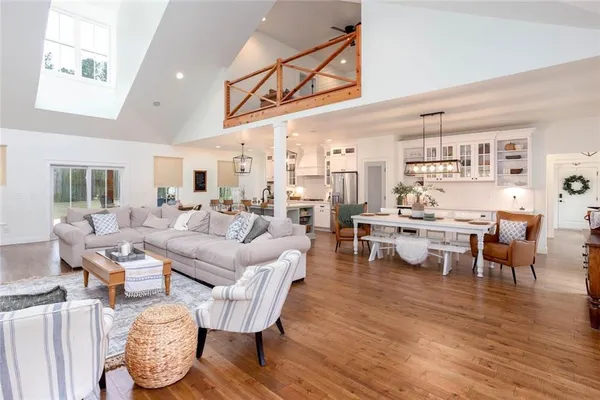 a view of a big house with a big yard and large trees