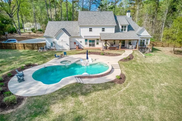 a view of a patio with table and chairs potted plants with floor to ceiling window