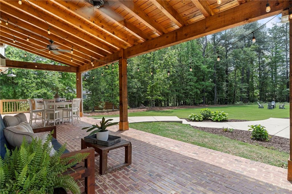 1273 Villa Rica Road Powder Springs, GA 30127 - Photo 35 of 69 a view of a patio with table and chairs potted plants with wooden floor and fence
