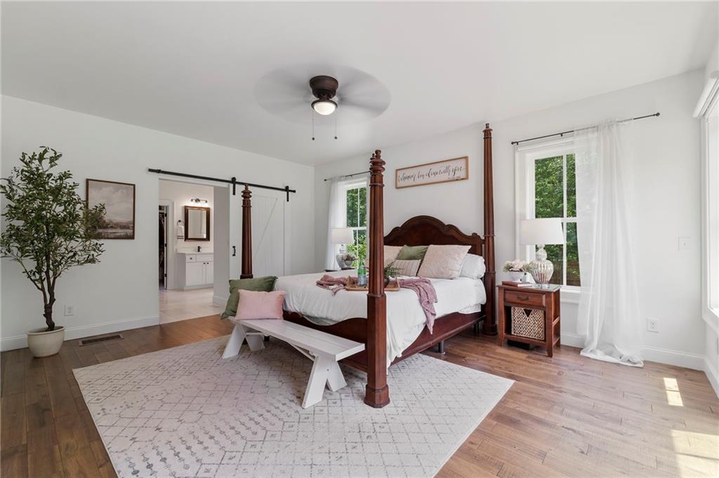 1273 Villa Rica Road Powder Springs, GA 30127 - Photo 36 of 69 a bedroom with a bed and a potted plant
