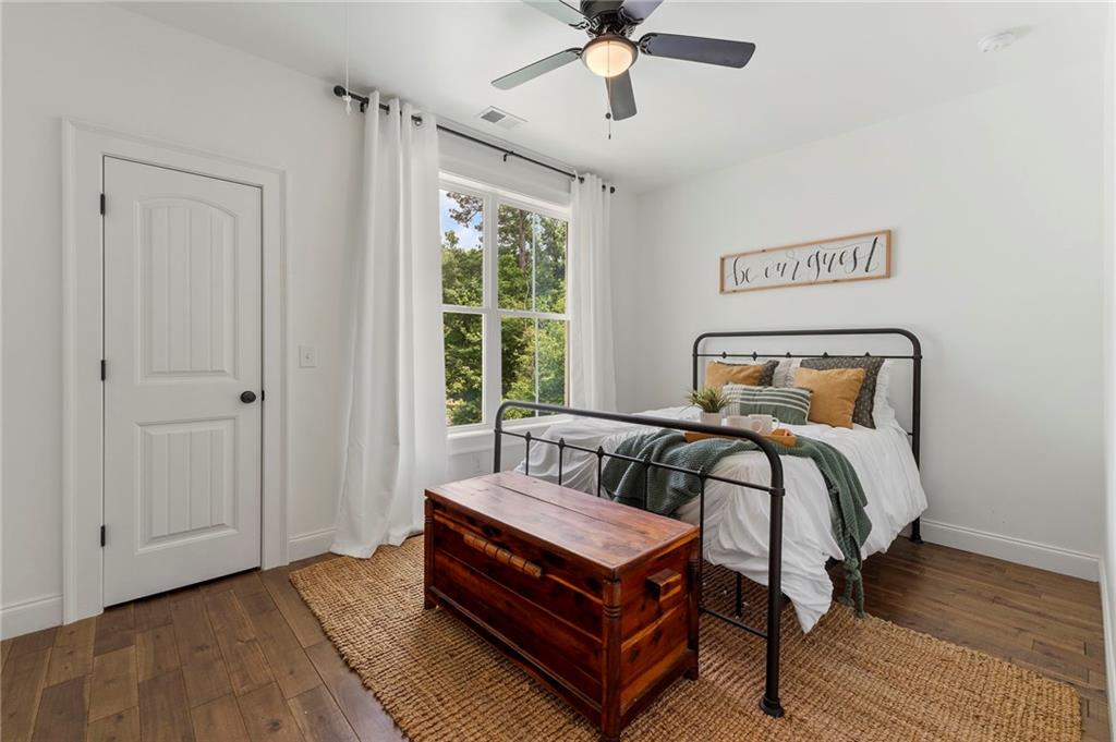 1273 Villa Rica Road Powder Springs, GA 30127 - Photo 53 of 69 a bedroom with a bed and wooden floor
