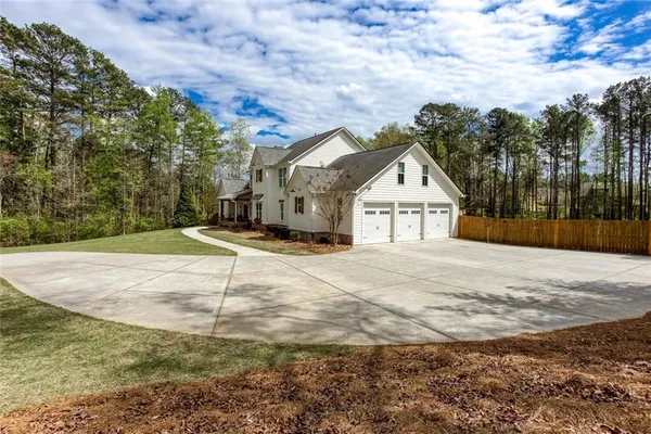 a view of a house with swimming pool and a yard