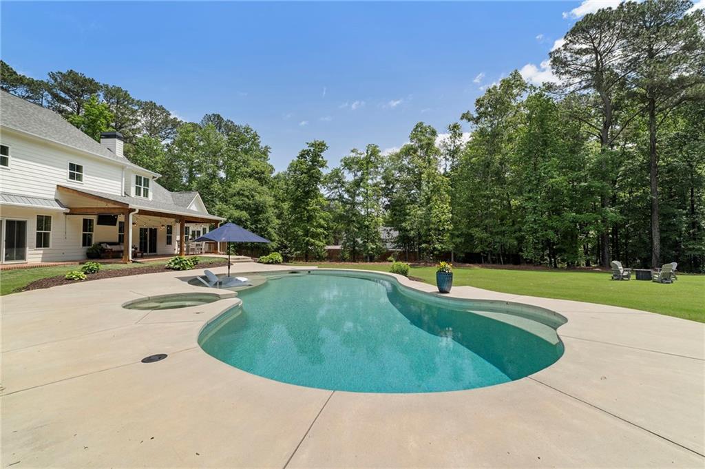 1273 Villa Rica Road Powder Springs, GA 30127 - Photo 63 of 69 a view of a swimming pool with a garden
