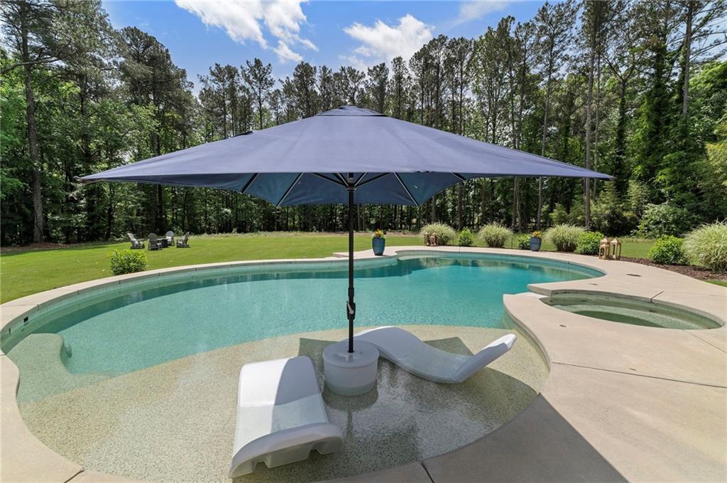 1273 Villa Rica Road Powder Springs, GA 30127 - Photo 65 of 69 a view of pool with table and chairs under an umbrella