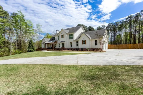 a view of a patio with furniture and a yard