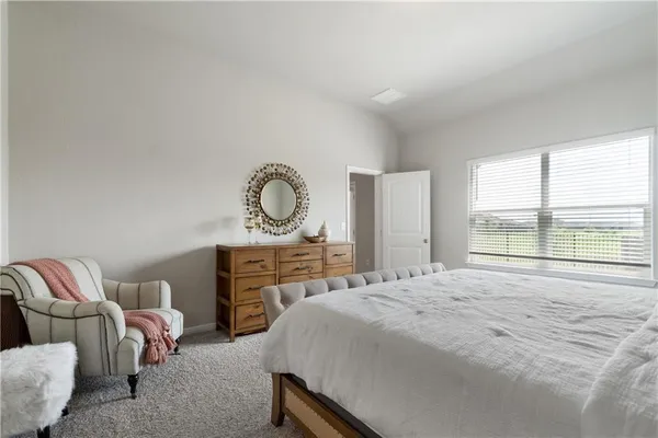 a bedroom with a bed and dresser