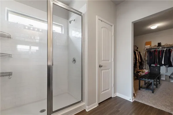 a view of a bathroom with a glass door shower