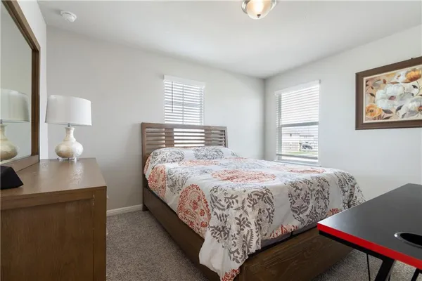 a bedroom with bed and night stand