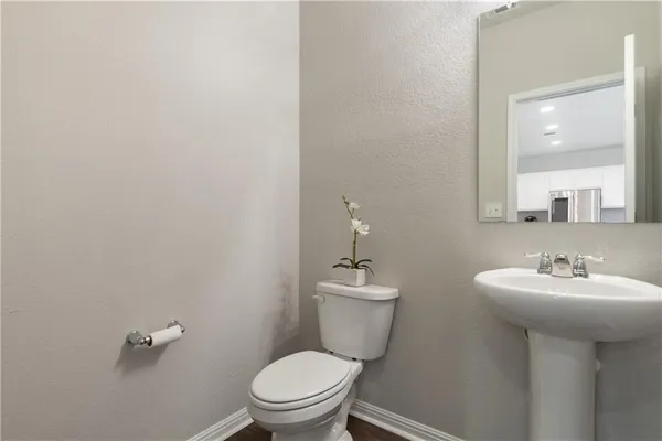 a bathroom with a sink mirror and toilet