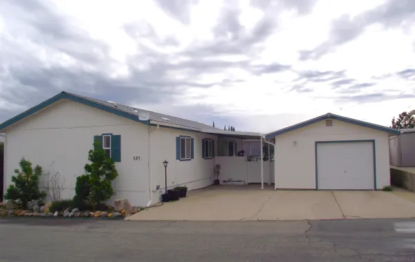 a view of a house with a yard and garage