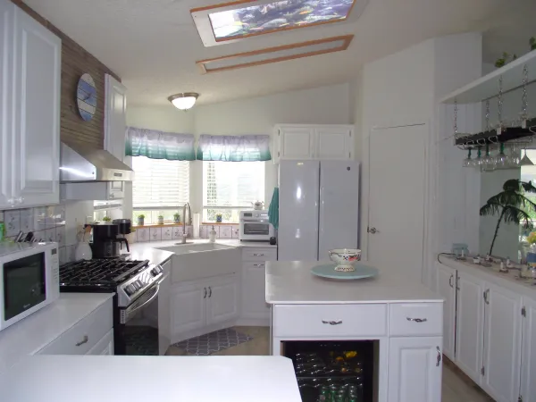 a view of kitchen with stainless steel appliances granite countertop a sink and a stove