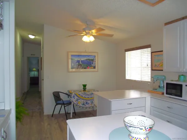 a room with patio furniture and a floor to ceiling window