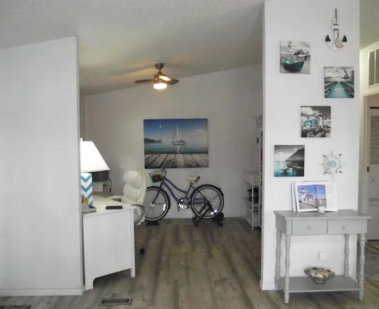 a bedroom with a bed and a lamp on dresser