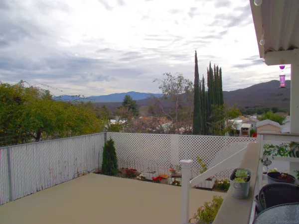 a view of a house with backyard and porch