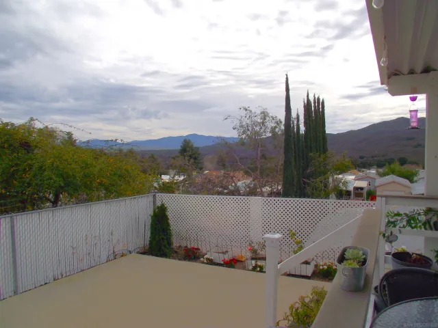 a view of a house with backyard and porch