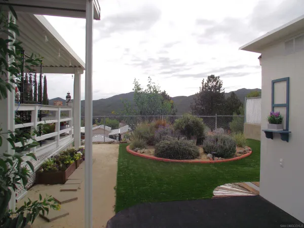 a view of a backyard with sitting area
