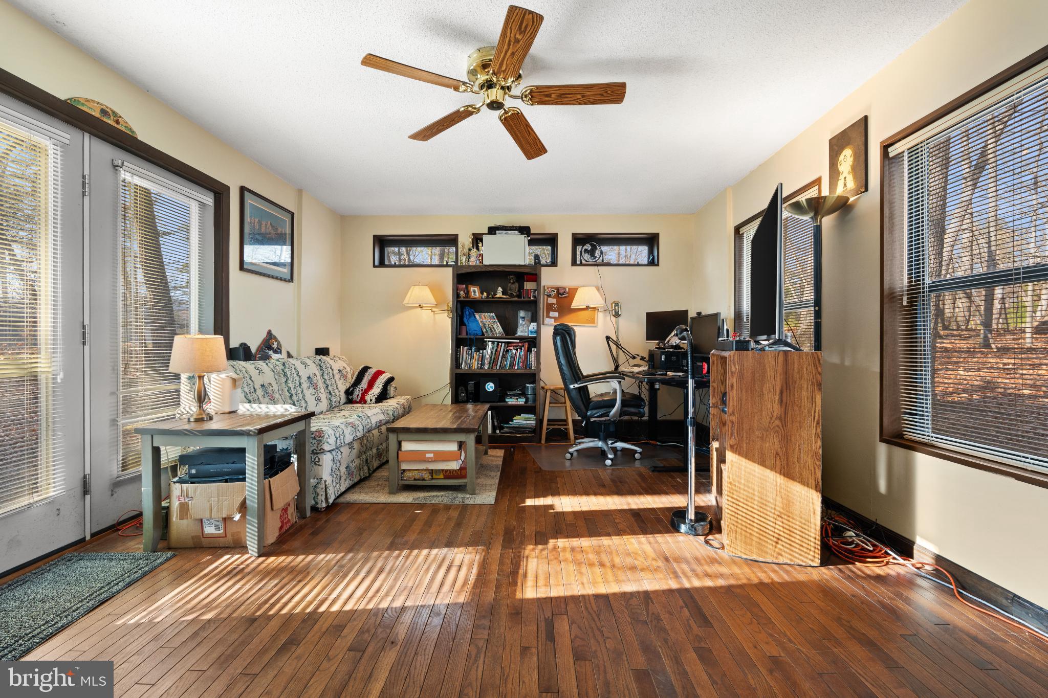 277 Endless Summer Road Hedgesville, WV 25427 - Photo 19 of 33 a living room with furniture mirror and wooden floor