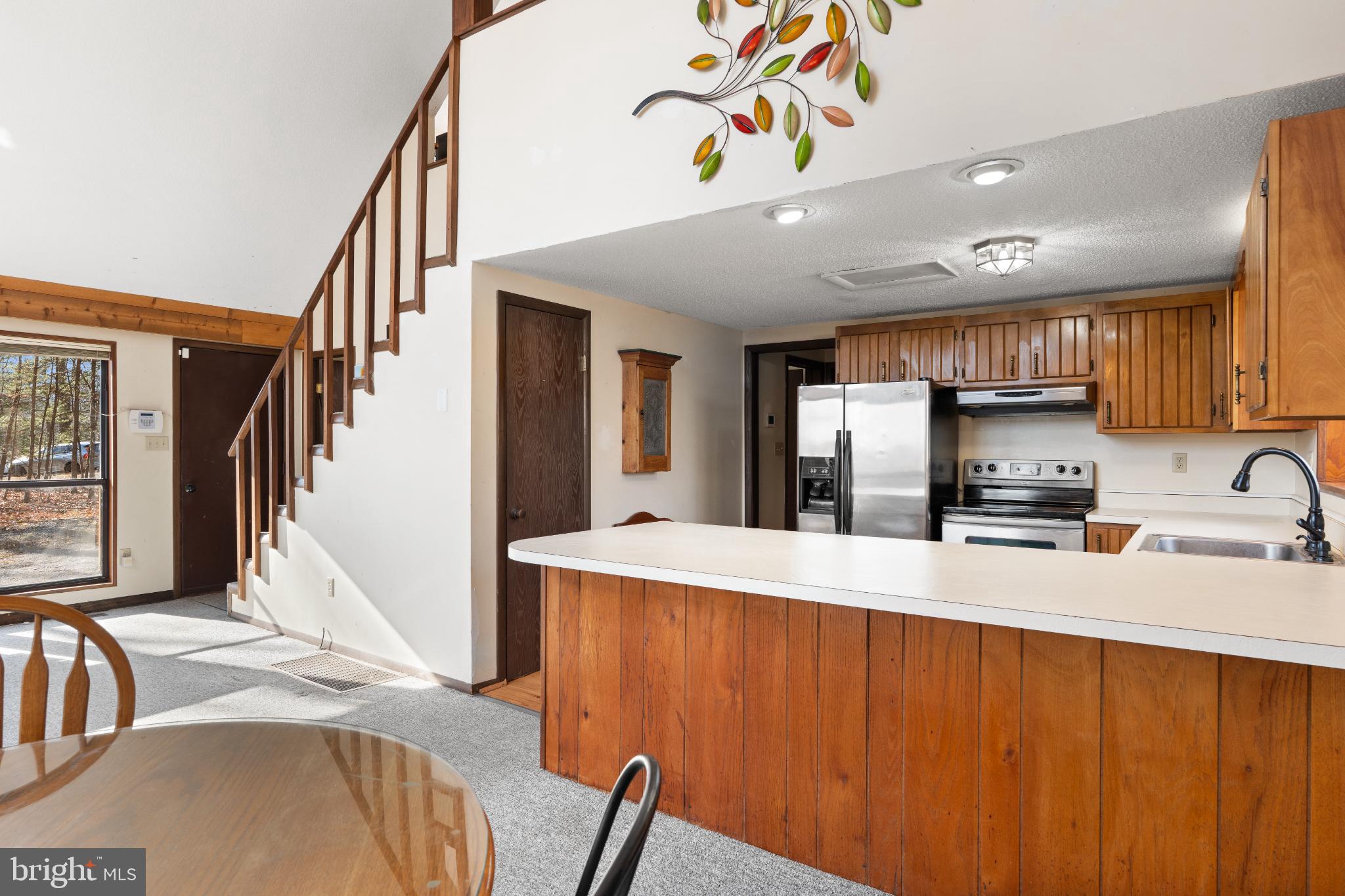 277 Endless Summer Road Hedgesville, WV 25427 - Photo 6 of 33 a kitchen with stainless steel appliances granite countertop a sink refrigerator and microwave