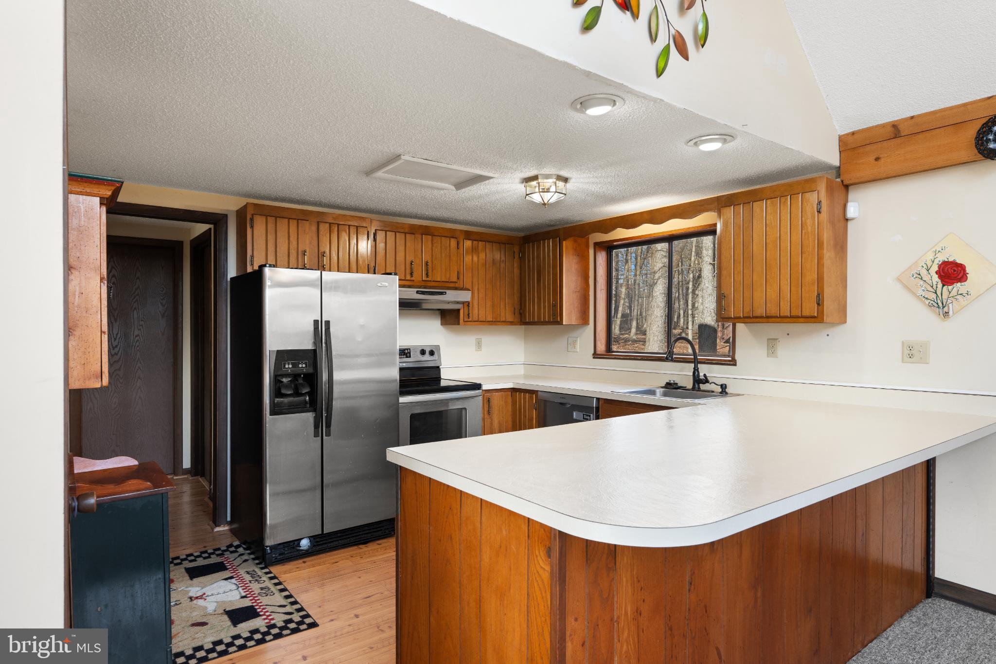 277 Endless Summer Road Hedgesville, WV 25427 - Photo 7 of 33 a kitchen with stainless steel appliances granite countertop a sink refrigerator and cabinets