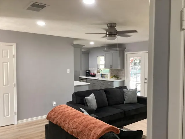 a living room with a couch and a chandelier