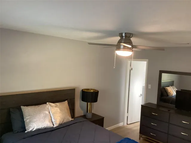 a bedroom with a bed and a dresser in it