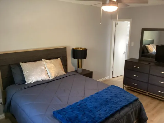 a bedroom with a bed and a dresser